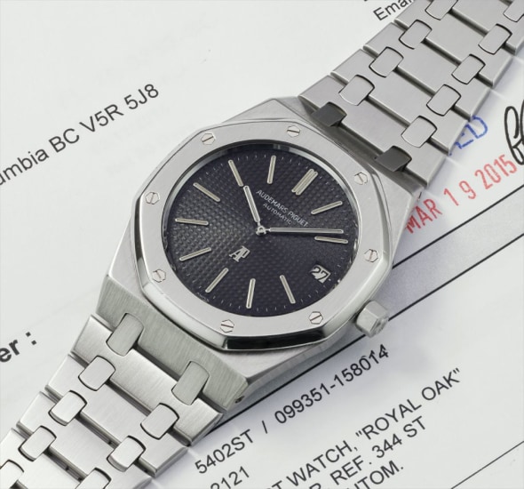 A very rare and attractive stainless steel wristwatch with date, bracelet and service papers